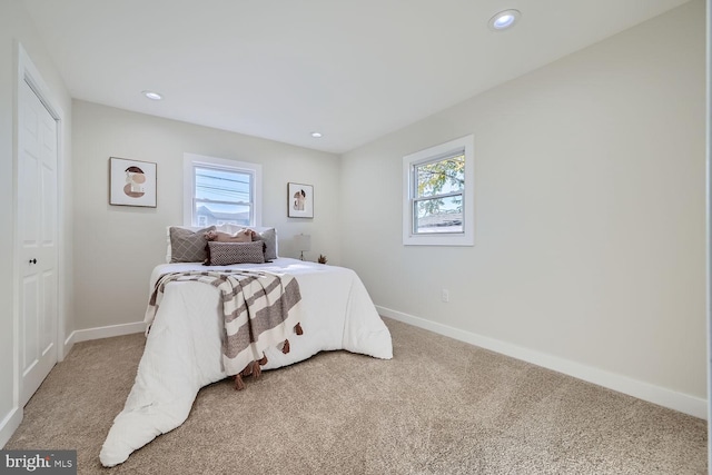 bedroom featuring multiple windows and carpet