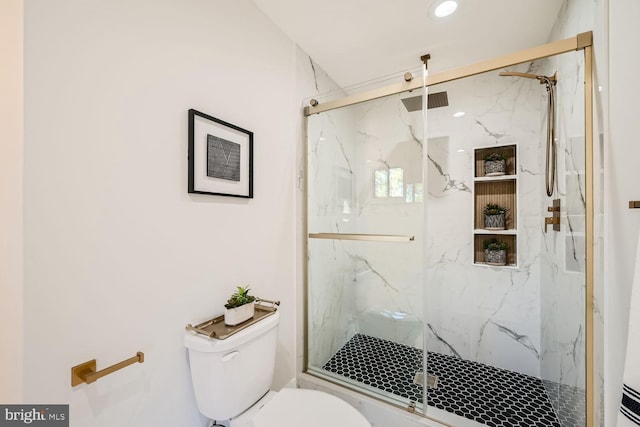 bathroom with toilet and an enclosed shower