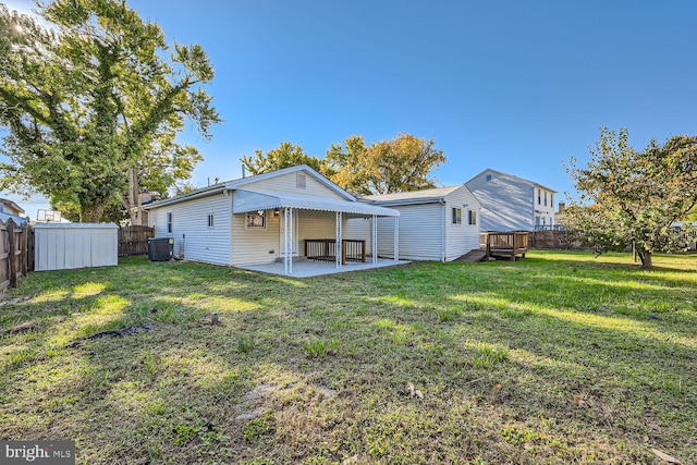 back of property featuring central air condition unit, a patio area, and a lawn