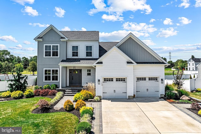 modern farmhouse style home with driveway, a shingled roof, fence, a front lawn, and a garage
