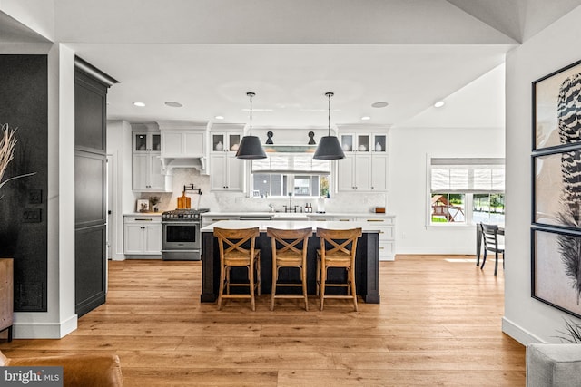 kitchen with gas range, a wealth of natural light, and white cabinets