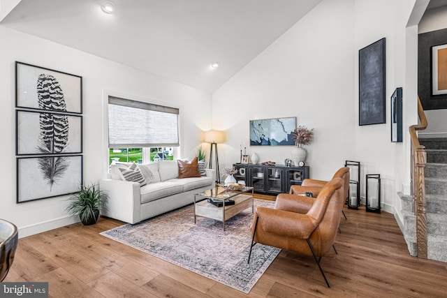 living room featuring hardwood / wood-style floors and high vaulted ceiling