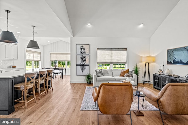 living room with lofted ceiling and light hardwood / wood-style floors