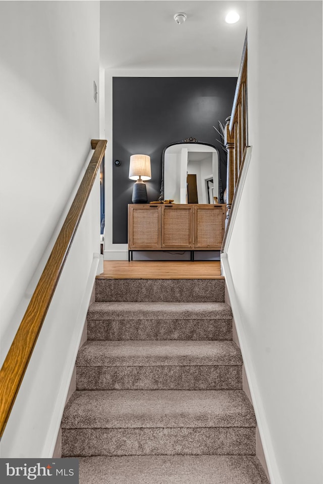 staircase featuring hardwood / wood-style floors