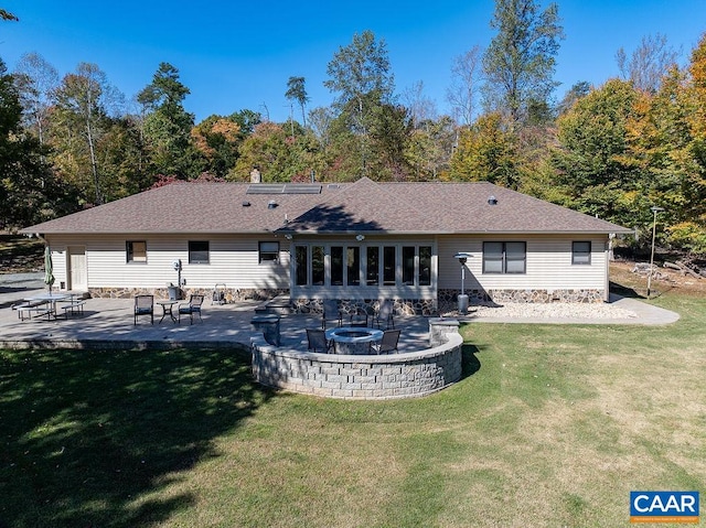 rear view of house featuring a yard and a patio