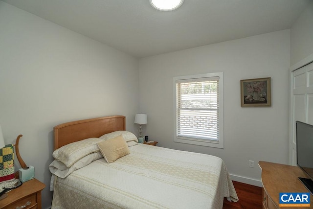 bedroom with dark wood-type flooring