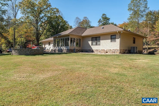 back of property featuring a patio area, central AC, and a lawn