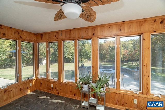 unfurnished sunroom featuring ceiling fan