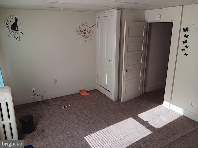 unfurnished bedroom with dark colored carpet