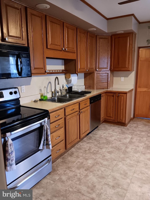 kitchen featuring crown molding, stainless steel appliances, and sink