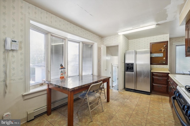 kitchen with stainless steel refrigerator with ice dispenser, black / electric stove, and plenty of natural light