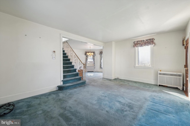 carpeted empty room featuring radiator