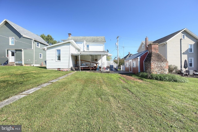 rear view of house with a yard