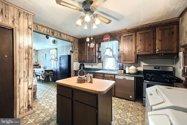 kitchen featuring black fridge, a center island, stainless steel dishwasher, gas range oven, and ceiling fan