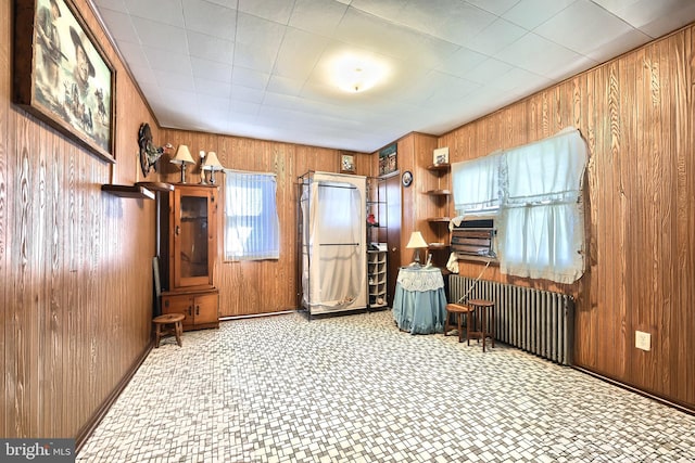 misc room with wooden walls and radiator heating unit