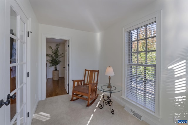 living area with light carpet