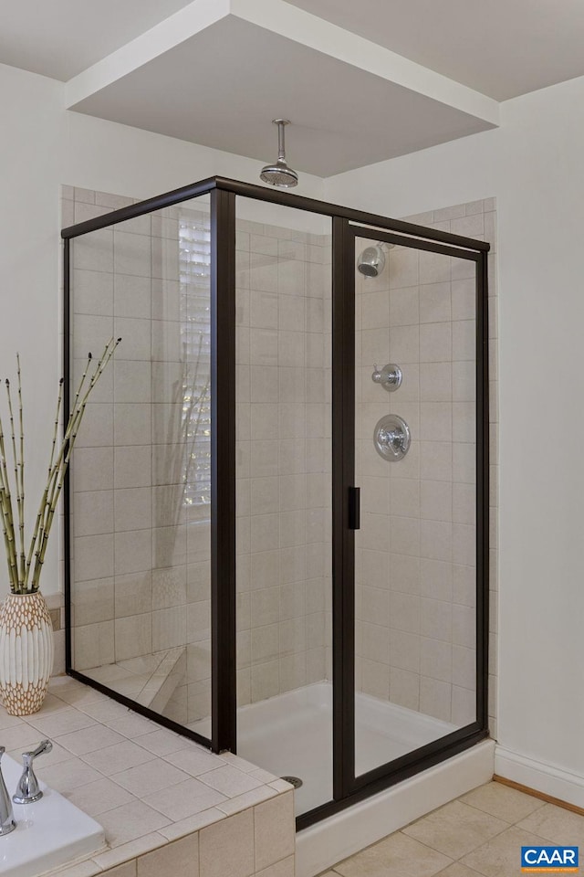 bathroom with tile patterned floors and a shower with shower door