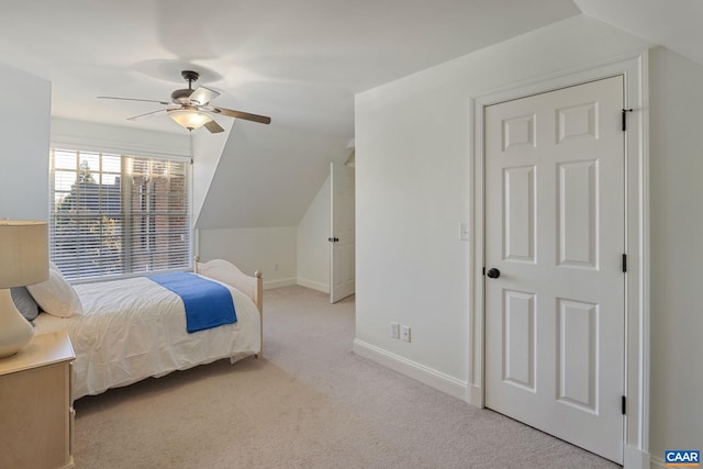 bedroom with lofted ceiling, light colored carpet, and ceiling fan