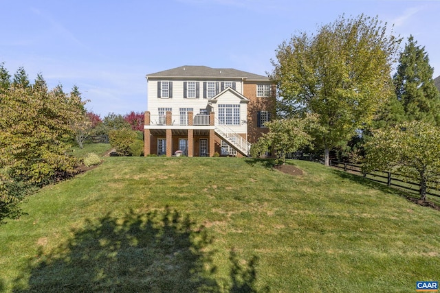 rear view of house featuring a lawn