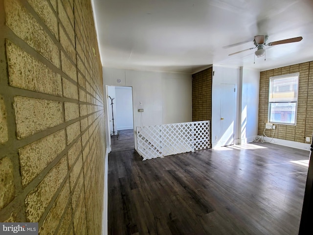 empty room with ceiling fan and dark hardwood / wood-style floors