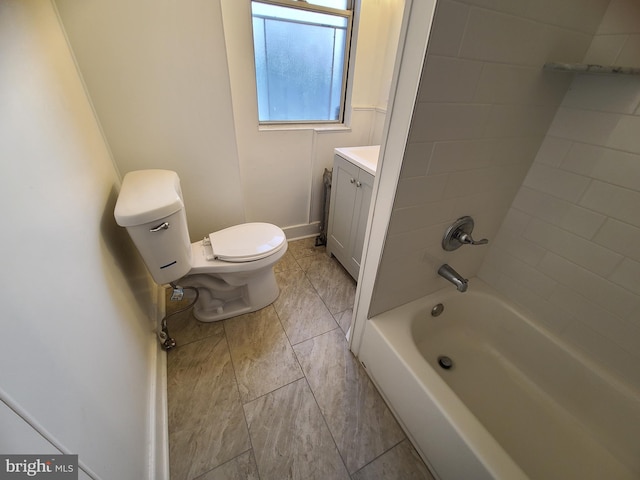 full bathroom featuring tiled shower / bath, vanity, and toilet