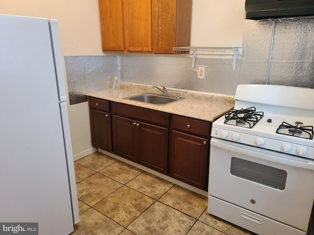 kitchen featuring sink, exhaust hood, white appliances, and light tile patterned floors