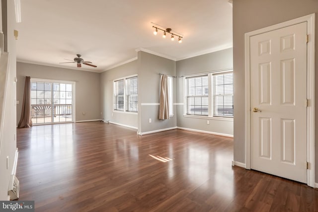 interior space featuring ceiling fan, rail lighting, dark hardwood / wood-style flooring, and ornamental molding