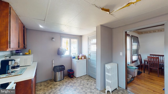 kitchen with refrigerator and radiator heating unit