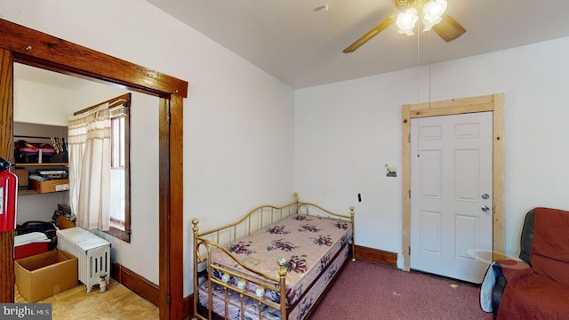 bedroom with ceiling fan, radiator heating unit, and carpet floors