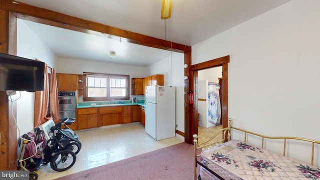 kitchen featuring decorative light fixtures, sink, and white refrigerator