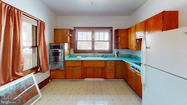 kitchen with stainless steel gas cooktop, sink, and white refrigerator