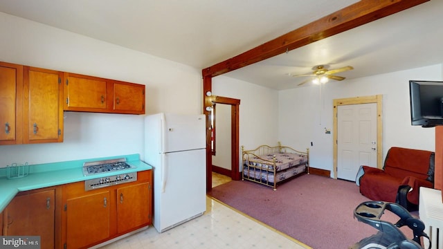 kitchen featuring beam ceiling, white fridge, and ceiling fan