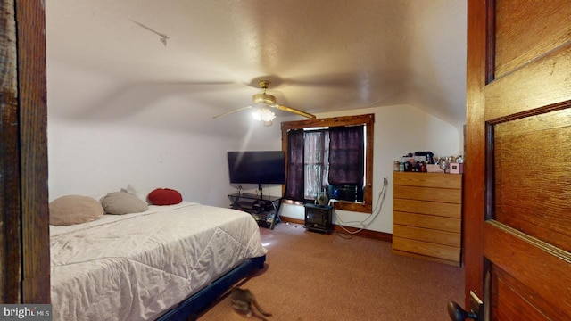 bedroom featuring lofted ceiling, carpet floors, and ceiling fan