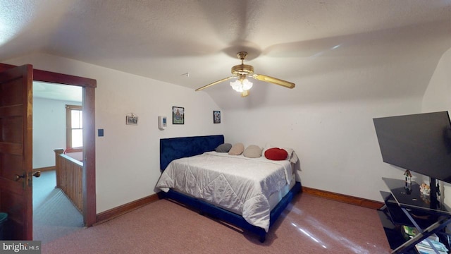 carpeted bedroom featuring lofted ceiling, a textured ceiling, and ceiling fan