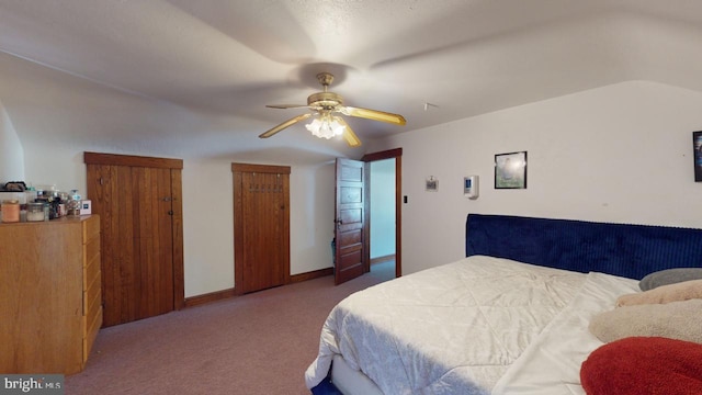 carpeted bedroom featuring lofted ceiling and ceiling fan