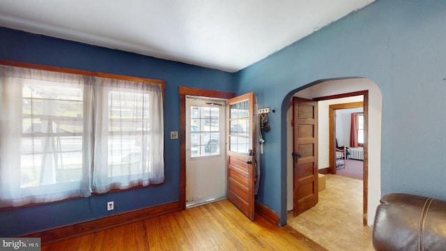 entryway featuring light hardwood / wood-style flooring and radiator heating unit