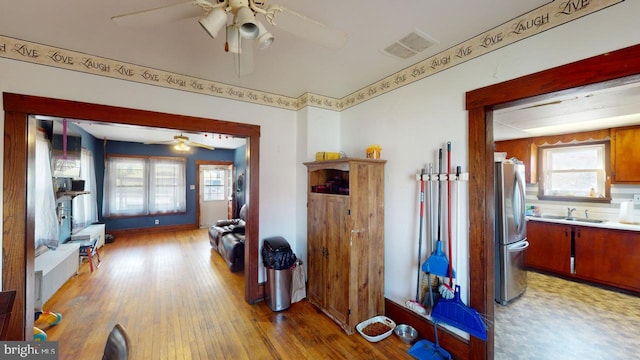 hallway featuring hardwood / wood-style floors and sink