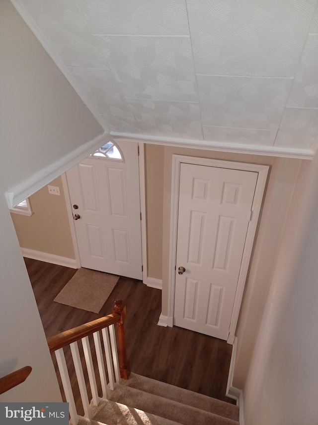 stairway with wood-type flooring and vaulted ceiling