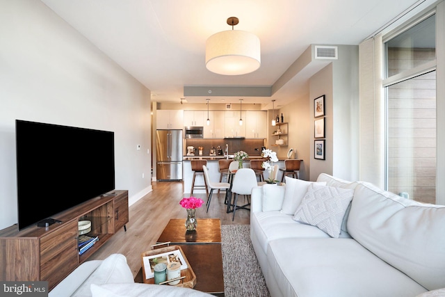 living room with light hardwood / wood-style flooring