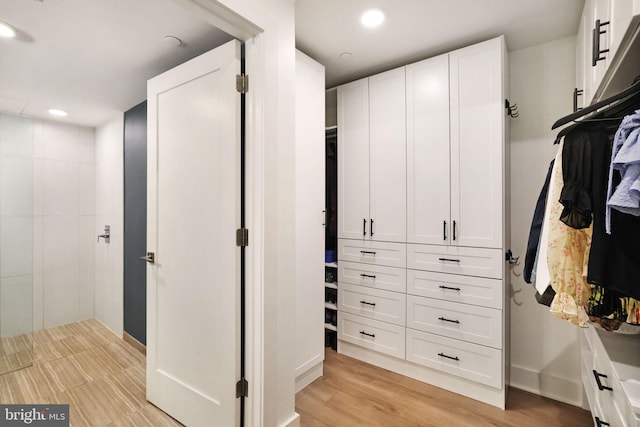 walk in closet featuring light wood-type flooring