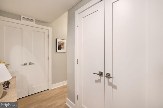 corridor featuring light hardwood / wood-style floors