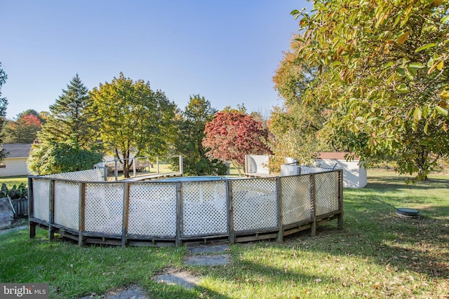 view of swimming pool with a lawn