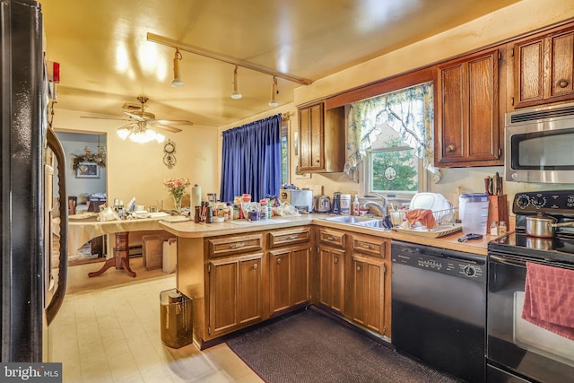 kitchen with black appliances, sink, kitchen peninsula, rail lighting, and ceiling fan