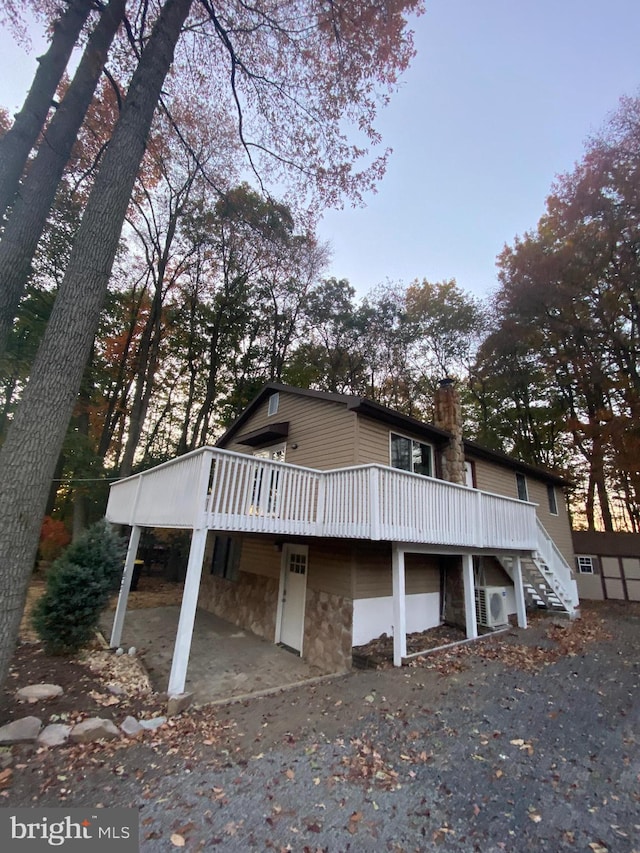 view of front facade with a wooden deck