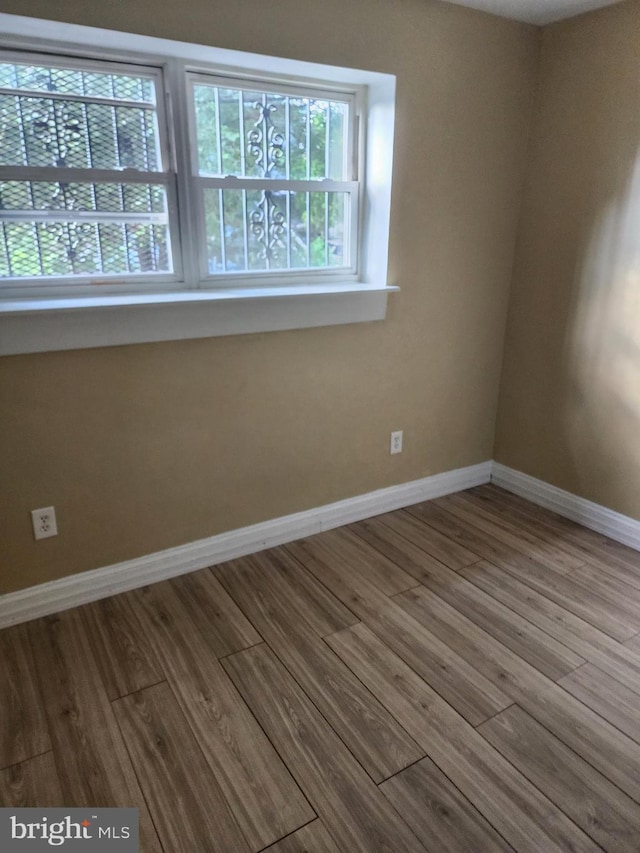 spare room featuring hardwood / wood-style floors