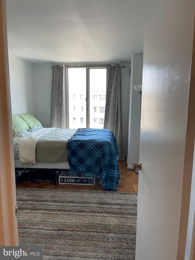 bedroom featuring parquet flooring