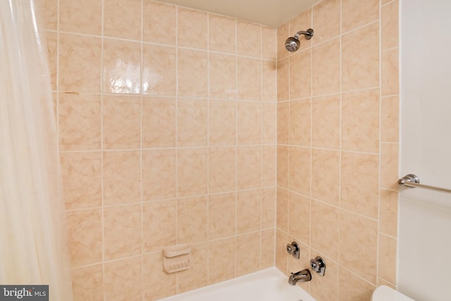 bathroom with shower / bath combo with shower curtain