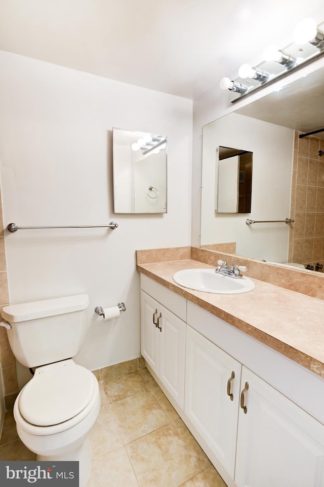 bathroom with vanity, toilet, and tile patterned floors