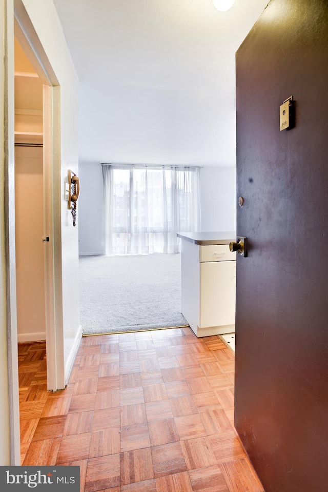 hallway featuring light carpet