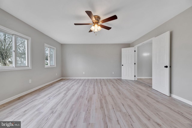 unfurnished room with ceiling fan and light wood-type flooring